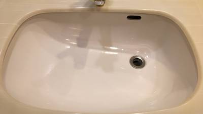 底面に小さな欠け傷がある人工大理石製の洗面ボウル全体写真